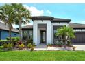 Charming one-story home with lush tropical landscaping and a welcoming entrance at 1919 Woodleaf Hammock Ct, Bradenton, FL 34211