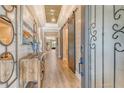 Elegant hallway featuring wood floors, stylish decor, and a unique ceiling design at 1919 Woodleaf Hammock Ct, Bradenton, FL 34211