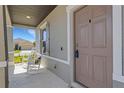 A charming front porch featuring two white rocking chairs and a view of the neighborhood at 2332 Mizner Bay Ave, Bradenton, FL 34208