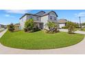 Well-manicured front lawn featuring lush green grass and mature landscaping elements at 2332 Mizner Bay Ave, Bradenton, FL 34208