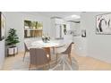 Bright breakfast nook features a marble table and modern white kitchen at 2410 Floyd St, Sarasota, FL 34239