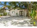 Charming single-story home with a well-manicured front yard, modern black trim, and black double door entry at 2410 Floyd St, Sarasota, FL 34239