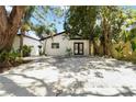 Charming single-story home with a well-manicured front yard, modern black trim, and black double door entry at 2410 Floyd St, Sarasota, FL 34239