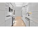 Bright kitchen features white cabinets, stainless steel appliances, and a skylight at 2410 Floyd St, Sarasota, FL 34239