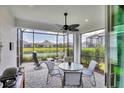 Relaxing screened patio with comfortable seating and a picturesque lake view at 2631 Sapphire Blue Ln, Bradenton, FL 34211