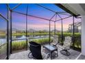 Screened patio with comfortable seating, overlooking a serene pond and neighborhood view at 2631 Sapphire Blue Ln, Bradenton, FL 34211