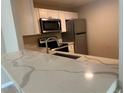 Kitchen featuring stainless steel appliances and modern countertops at 2650 Coconut Bay Ln # 521, Sarasota, FL 34237