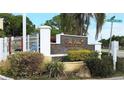 The Palms Condominiums sign in front of lush landscaping at 2650 Coconut Bay Ln # 521, Sarasota, FL 34237