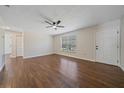 Living room showcasing new wood-look floors, ceiling fan and a front-facing window at 2953 Oak St, Sarasota, FL 34237