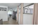 Bright living room with neutral décor, open floor plan with an adjacent dining area and modern stainless steel refrigerator at 3730 Ferguson St, Sarasota, FL 34233