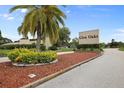 Entrance to Glen Oaks community featuring lush landscaping and signage at 3816 Blue Stone Way # 97, Sarasota, FL 34232