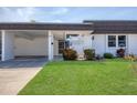 Charming single-story home with a carport and well-manicured front lawn at 3816 Blue Stone Way # 97, Sarasota, FL 34232