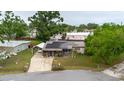 Aerial view of the house featuring solar panels, a screened porch, landscaping, and a carport at 4015 Asbury Pl, Sarasota, FL 34233