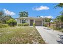 Cozy one-story home featuring a well-groomed front yard, concrete driveway and an attached one car garage at 4251 Austin St, Sarasota, FL 34233