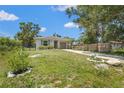 Well-kept home with a long driveway, lush lawn, landscaping, and a cozy, inviting one car garage at 4251 Austin St, Sarasota, FL 34233