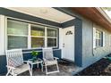 Inviting front porch features seating area with views to the front yard at 4310 7Th W Ave, Bradenton, FL 34209