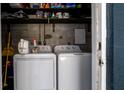 Laundry area features a washer, dryer, and shelving for storage at 4310 7Th W Ave, Bradenton, FL 34209