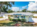 Attractive single-story home with a well-manicured lawn, white fence, and lush landscaping at 4375 Tortoise Rd, Venice, FL 34293