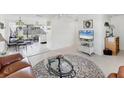 Open-concept living room with view to adjacent dining area and sliding glass doors to back patio at 4535 Maceachen Blvd, Sarasota, FL 34233