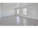 Spacious living room with new wood-look flooring, neutral paint, and great natural light at 478 Orange Nw Dr, Port Charlotte, FL 33952