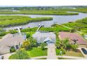 Aerial view of the property with a pool, lush landscaping, and waterfront access with a private dock at 4844 14Th E Ave, Bradenton, FL 34208