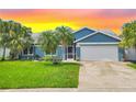 Charming single-story home with well-maintained lawn, lush palm trees, and a two-car garage at 4844 14Th E Ave, Bradenton, FL 34208