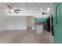 Spacious living room with white walls, tile floor, and open access to kitchen at 500 N Jefferson Ave # G5, Sarasota, FL 34237