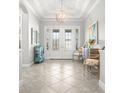 Bright foyer with a decorative light fixture, neutral walls, and an open floor plan at 5011 Tivoli Run, Bradenton, FL 34211