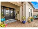 Inviting front porch with double glass doors, decorative plants, and a cozy seating area at 5011 Tivoli Run, Bradenton, FL 34211