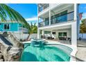 Beautiful pool and spa with a slide, lounge chairs, and an outdoor dining area at 5219 Calle Menorca, Sarasota, FL 34242