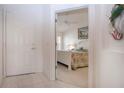 Condo entrance featuring an open door to a bedroom with a white coastal style bed at 5330 Hyland Hills Ave # 2324, Sarasota, FL 34241