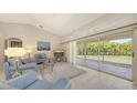 Bright living room features vaulted ceilings and sliding glass doors to the outdoor space at 5698 Country Walk Ln, Sarasota, FL 34233