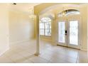 Bright foyer featuring tile floors, a decorative chandelier, and double doors with glass inserts at 5905 32Nd E St, Ellenton, FL 34222