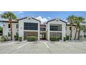 Charming condo exterior with two-story units, balconies and well maintained landscaping at 631 N Orange Ave # 208, Sarasota, FL 34236