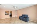 Bright living room featuring tile floors, ceiling fan, and open access to the kitchen at 631 N Orange Ave # 208, Sarasota, FL 34236