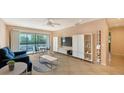 Cozy living room with dining area, large window, and contemporary shelving unit at 631 N Orange Ave # 208, Sarasota, FL 34236