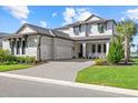 Charming two-story home with a three-car garage, well-manicured lawn, and a paver driveway at 6349 Isla Del Ray Ave, Sarasota, FL 34240