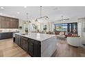 Spacious kitchen island boasts bar seating and views of the open living space with water views at 6349 Isla Del Ray Ave, Sarasota, FL 34240