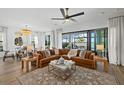 Open living room boasts hardwood floors, stylish decor, and expansive sliding doors to the lanai at 6349 Isla Del Ray Ave, Sarasota, FL 34240