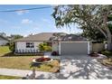 Charming single Gathering home featuring a manicured lawn, a two-car garage, and beautiful curb appeal at 6572 Mauna Loa Blvd, Sarasota, FL 34241