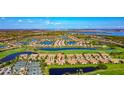 Stunning aerial view of the property surrounded by lakes and lush landscaping at 7106 Grand Estuary Trl # 102, Bradenton, FL 34212