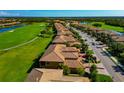 Aerial view of the community showcasing the well-manicured landscaping and golf course at 7106 Grand Estuary Trl # 102, Bradenton, FL 34212