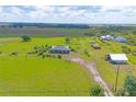 Wide aerial view of a home and extensive property including outbuildings and greenery at 7745 Wauchula Rd, Myakka City, FL 34251