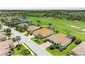 Stunning aerial view of the home, showcasing the tile roof, proximity to the golf course, and surrounding community at 8206 Heritage Grand Pl, Bradenton, FL 34212