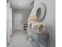 Bright entryway features ceramic tile, decorative table and mirror, and a modern decor style at 9148 Royal River Cir, Parrish, FL 34219