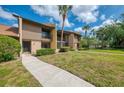 Beautiful condo featuring a well maintained lawn and tropical palm trees in the community at 933 Sunridge Way # B5, Sarasota, FL 34234