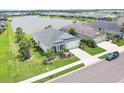 Aerial view showcases a well-maintained property with a pond view and lush landscaping at 13549 Old Creek Ct, Parrish, FL 34219