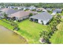 Expansive backyard view with a screened-in lanai, overlooking the tranquil lake at 13549 Old Creek Ct, Parrish, FL 34219