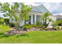 Beautifully landscaped yard of this single-Gathering home highlights the manicured lawn and vibrant foliage at 13549 Old Creek Ct, Parrish, FL 34219