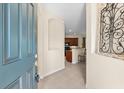 View from the front door showing the tiled foyer, open to the kitchen and main living area at 138 Tiziano Way, North Venice, FL 34275